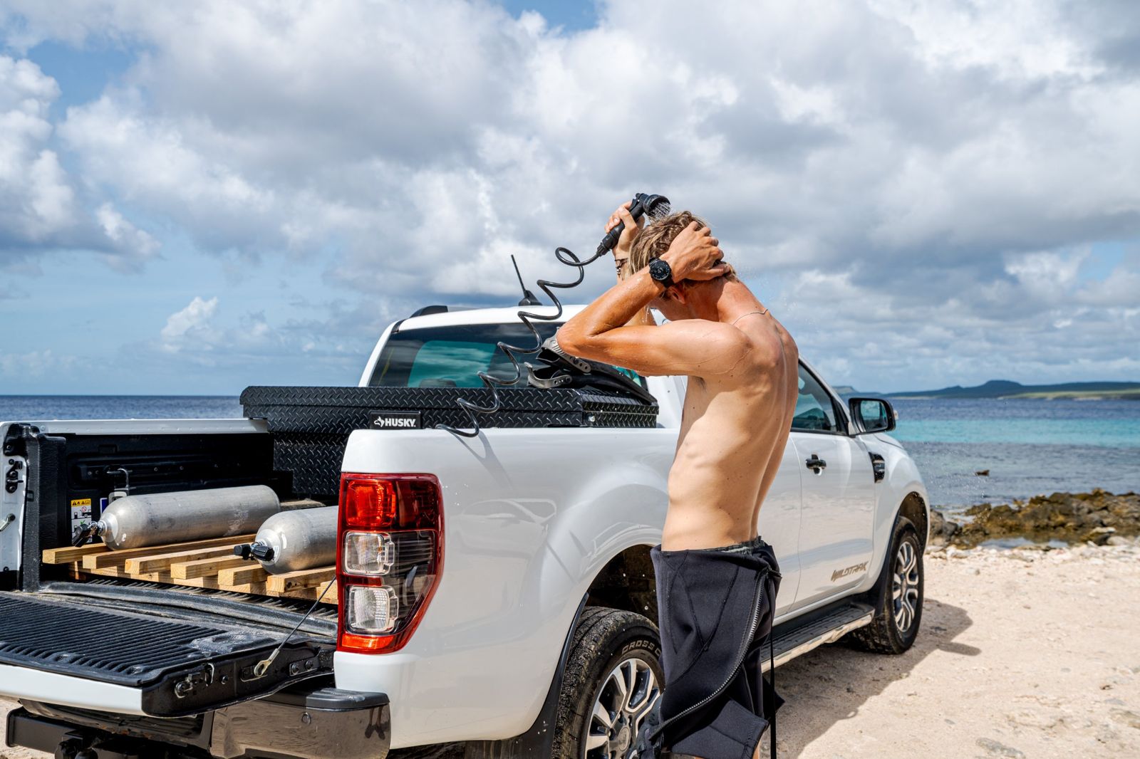 Diver rinsing off with the on-board freshwater shower